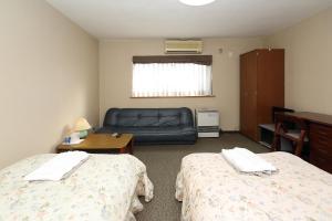 Postel nebo postele na pokoji v ubytování Hotel Tensui