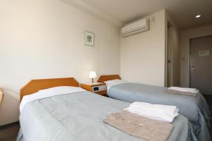 Postel nebo postele na pokoji v ubytování Hotel Tensui