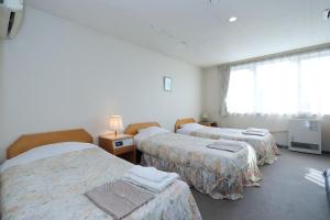 Postel nebo postele na pokoji v ubytování Hotel Tensui