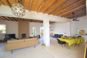a living room with a yellow table and a couch at La Villa douce in Marrakesh