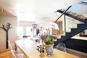 a dining room with a table and a staircase at Collection Luxury Apartments - Rozenhof Villa in Stellenbosch