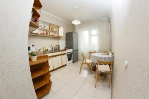 a kitchen with a table and a dining room at Двухкомнатные просторные апартаменты RentHome в ЖК Кемерово-Сити in Kemerovo