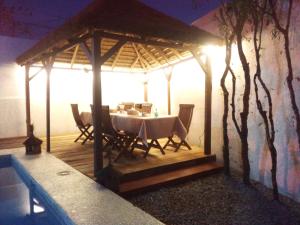 a gazebo with a table and chairs in it at Villa Mango in Abidjan