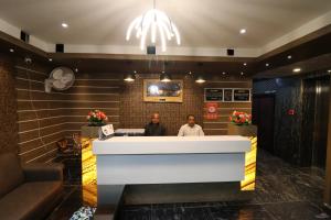two men sitting at a reception desk in a lobby at HOTEL PRATAP GRAND in Rānchī