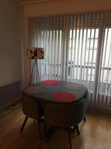 a table and chairs in a room with a window at PETIT STUDIO SYMPA EN CENTRE VILLE in Le Touquet-Paris-Plage +2 photos