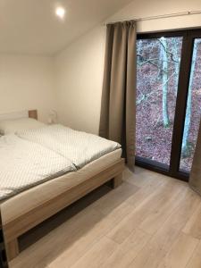 Postel nebo postele na pokoji v ubytování Tále Apartmán 9, Lúčnica, Chopok juh