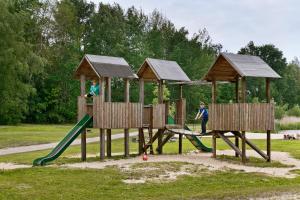 two children playing on a playground in a park at KNAUS Campingpark Oyten in Oyten