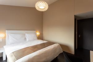 Voodi või voodid majutusasutuse Hotel Lo! im Kreuz Jona toas