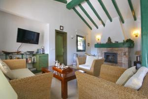 a living room with chairs and a fireplace at La Cumbre in Jávea