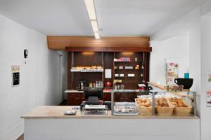 a bakery with a counter with baskets of bread at KNAUS Campingpark Hennesee in Meschede