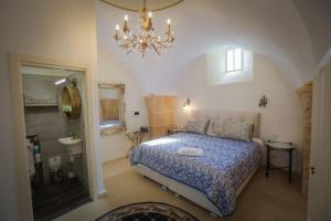 a bedroom with a bed and a chandelier at Western Wall Luxury House in Jerusalem