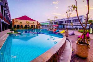 a large swimming pool in the middle of a building at Front One Akshaya Hotel Karawang in Karawang
