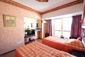 Rúm í herbergi á Sud Bahia Agadir "Bahia City Hotel"