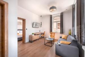 a living room with a couch and a table at Hotel Vila Pohorje in Slovenj Gradec