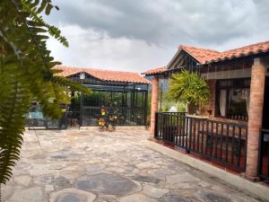 a house with a gate and a patio at Posadas San Antonio Campestre in Tibasosa
