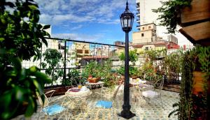 a patio with tables and chairs and a street light at Poetry Building Recoleta in Buenos Aires