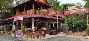 a restaurant with tables and chairs in front of it at Papa Pippo Otres Village in Sihanoukville