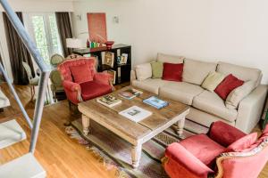 a living room with a couch and a coffee table at Poetry Building Recoleta in Buenos Aires +14 photos