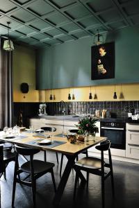 a kitchen with a table and chairs in a room at Manoir de Collonges au mont d'or in Collonges-au-Mont-dʼOr