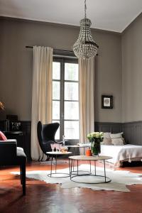 a bedroom with a bed and a chair and a table at Manoir de Collonges au mont d'or in Collonges-au-Mont-dʼOr +16 photos