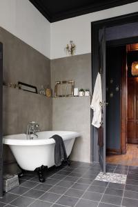 a bathroom with a white tub in a room at Manoir de Collonges au mont d'or in Collonges-au-Mont-dʼOr