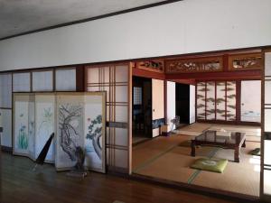 a room with a table and some glass doors at 田舎生活体験福井県観光者向け古民家 in Sabae