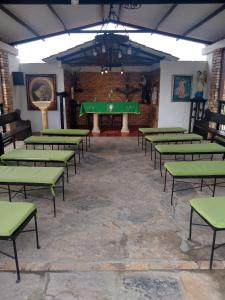 a room with a pool table and green tables at Posadas San Antonio Campestre in Tibasosa