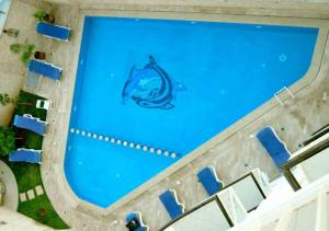 an overhead view of a swimming pool with a dolphin painted on it at Suite Hotel Tilila in Agadir
