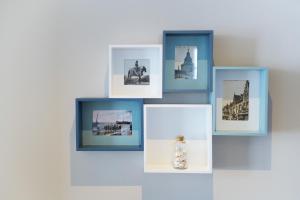 a group of pictures on a wall with a vase at Jeanne in Nieuwpoort