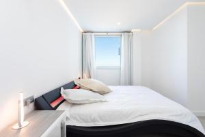 a bedroom with a bed with a window at Oceanfront Rental in Adeje