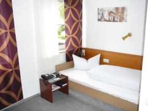 Postel nebo postele na pokoji v ubytování Hotel Garni Schmid