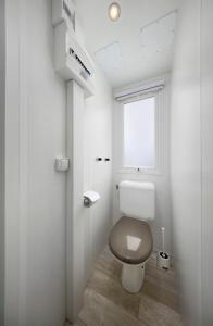 La salle de bains est pourvue de toilettes et d'une fenêtre. dans l'établissement KNAUS Campingpark Eckwarderhörne, à Eckwarderhörne