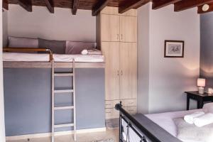 a room with two bunk beds and a ladder at Forest View Apartments in Tríkala