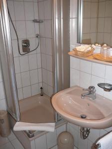 a bathroom with a sink and a shower at Hotel Garni Schmid in Neu Ulm