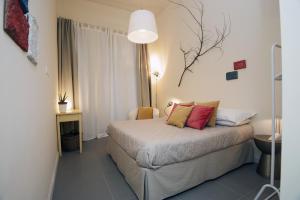 a bedroom with a bed with two pillows on it at B&B Torino Crocetta in Turin