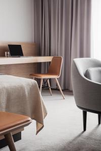 a room with a bed and a desk and a chair at Copenhagen Admiral Hotel in Copenhagen