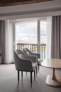 a room with chairs and a table and a large window at Copenhagen Admiral Hotel in Copenhagen