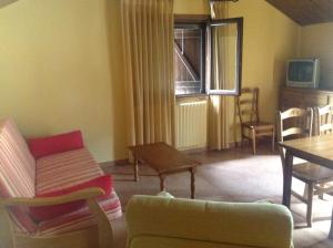 a living room with a couch and a table at Casa Diego Apartamentos Turisticos in Gavín