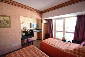 Rúm í herbergi á Sud Bahia Agadir "Bahia City Hotel"