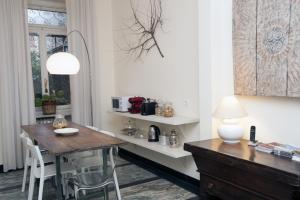a dining room with a wooden table and chairs at B&B Torino Crocetta in Turin +35 photos