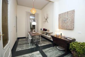 a dining room with a table and a desk at B&B Torino Crocetta in Turin