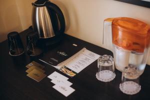 a counter top with a blender and a coffee pot at Alex Hotel in Odesa
