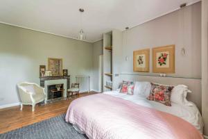 a bedroom with a large bed and a fireplace at Manoir du Moulin in Sainte-Hermine