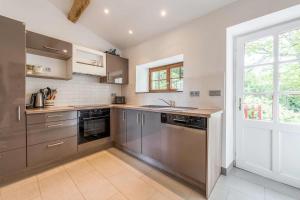a kitchen with stainless steel appliances and a window at Manoir du Moulin in Sainte-Hermine