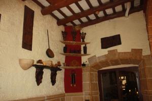 a room with a stone wall with shelves and a fireplace at Hostal Restaurante La Diligencia in Cunit