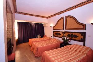 Rúm í herbergi á Sud Bahia Agadir "Bahia City Hotel"