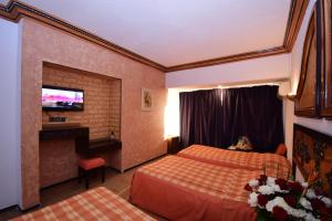 Rúm í herbergi á Sud Bahia Agadir "Bahia City Hotel"