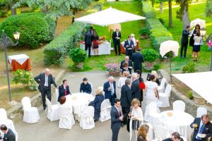 a group of people standing around a table at a wedding at Villa Pambuffetti in Montefalco
