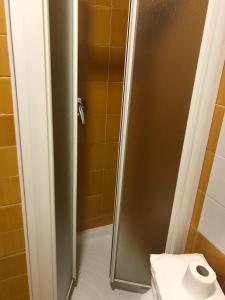 a bathroom with a shower with a roll of toilet paper at Hotel Fly in Casoria