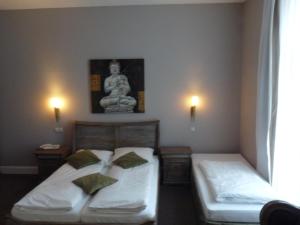 Postel nebo postele na pokoji v ubytování Hotel Commodore